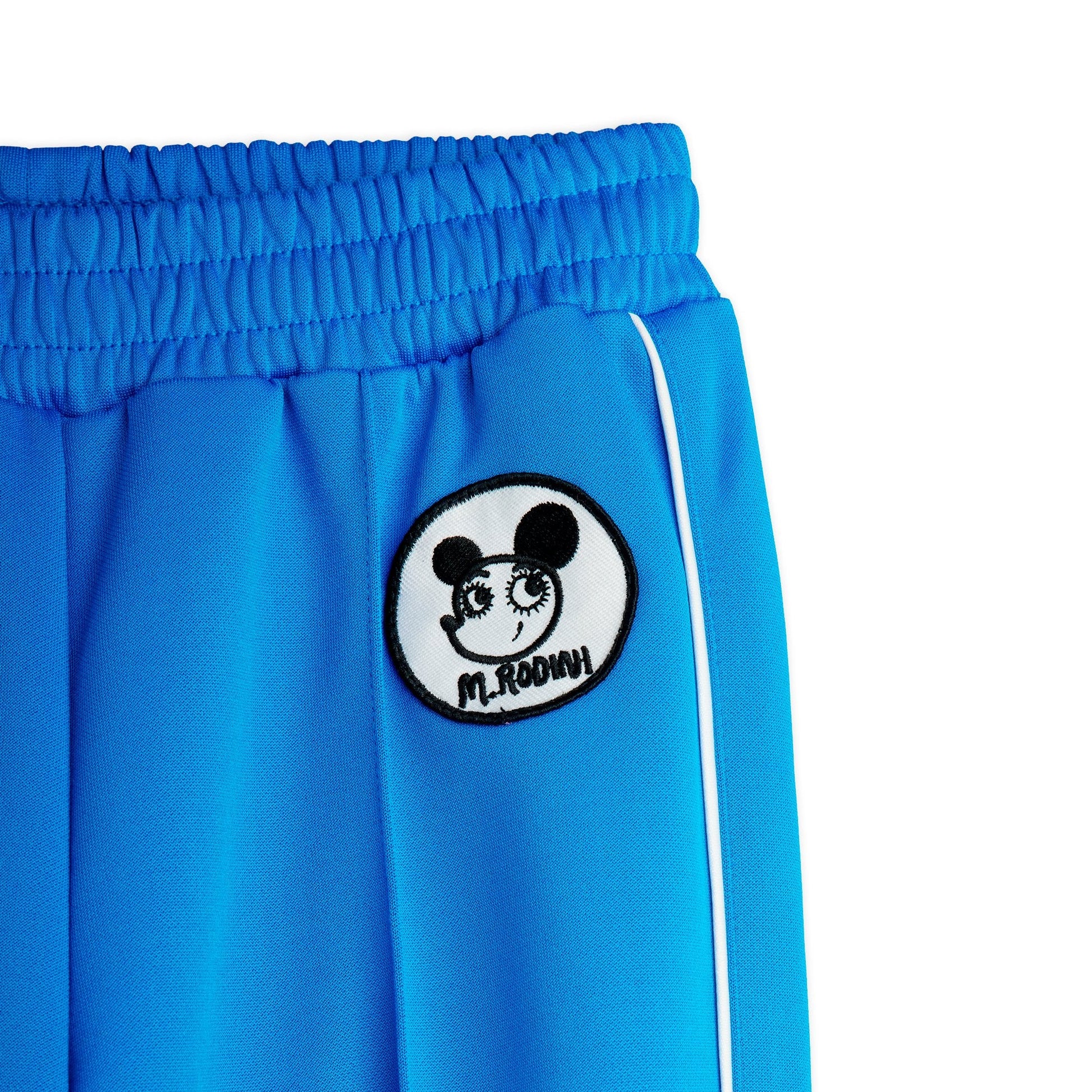 Blue pants with a black and white logo on a white background