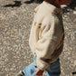 Child wearing Konges Sløjd Magot Pants in Lemon Denim – A little one stepping out in the Magot Pants, paired with a teddy fleece jacket and wellies. Effortless style meets playful practicality.