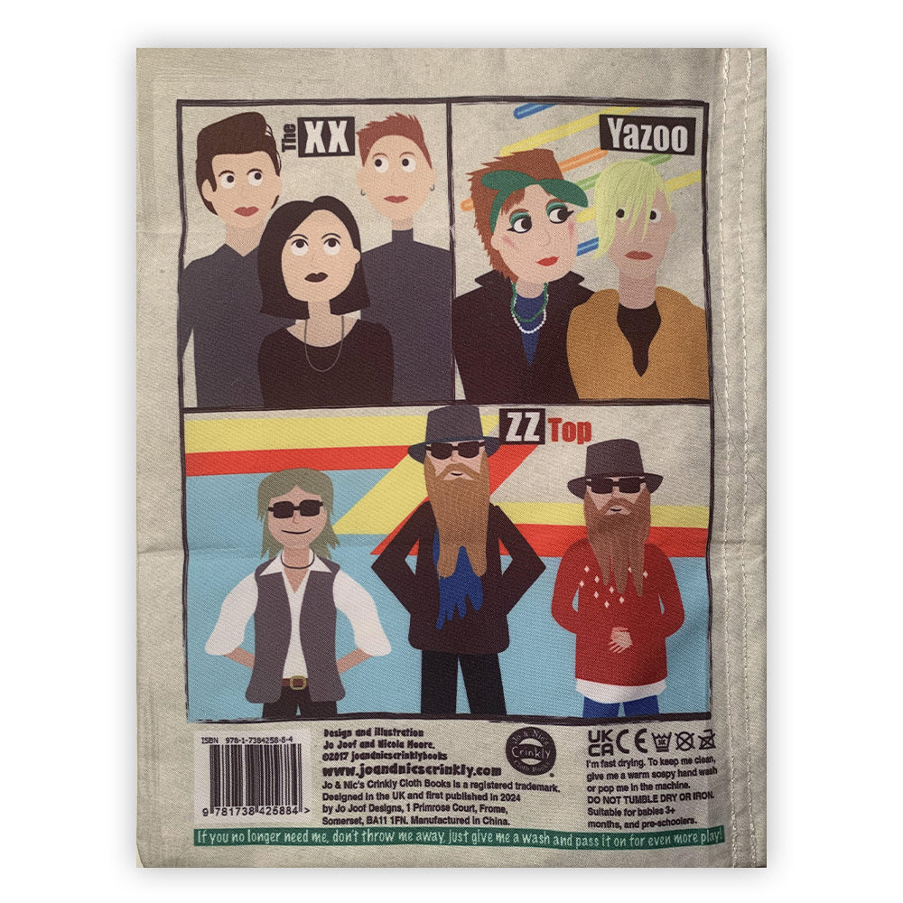 A colourful cloth book designed to look like a crinkly newspaper. The book features six brightly illustrated pages showcasing popular music artists, with crinkly texture and soft fabric. It is presented on a neutral background, emphasizing its lightweight and sensory appeal for babies and toddlers. Shown from the back with illustrations of The XX, Yahoo, and ZZ Top