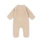Beige baby onesie with bunny ears on a white background