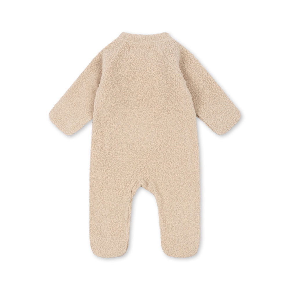 Beige baby onesie with bunny ears on a white background