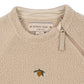 Beige fleece jacket with a lemon embroidered logo and Konges Slojd label.