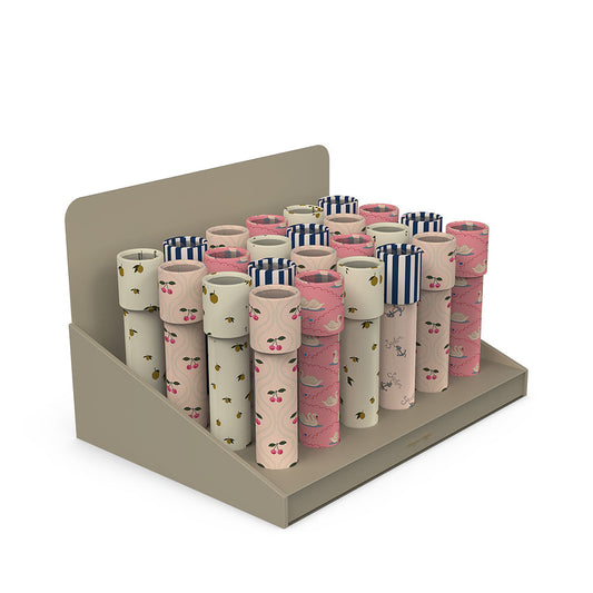 Display of toilet paper rolls with decorative patterns on a beige stand against a white background