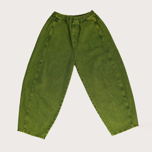 A pair of wide-leg, barrel-shaped trousers in a textured green shade with an elasticated waistband, side pockets, and a back patch pocket. The trousers feature displaced seams for a rounded leg shape, offering a modern and relaxed fit. Made from 20% recycled cotton and styled for unisex wear.