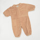 Studio Koter Rae Oversized Teddy Boilersuit in warm caramel, showcasing the soft texture of the 100% organic cotton teddy fleece. The image highlights the zip front, elasticated cuffs, and spacious patch pockets, emphasizing the cozy and functional design perfect for cooler days. 