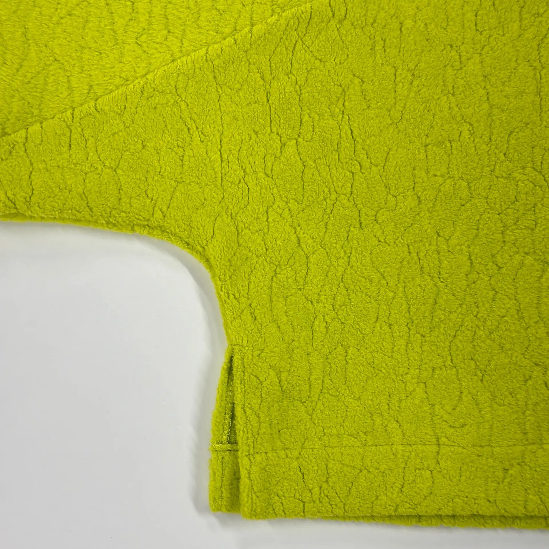 Close-up of the Studio Koter River Teddy Sweatshirt in vibrant acid green, showcasing the unique texture of the 100% organic cotton teddy fleece. The image highlights the soft, tactile quality of the fabric.