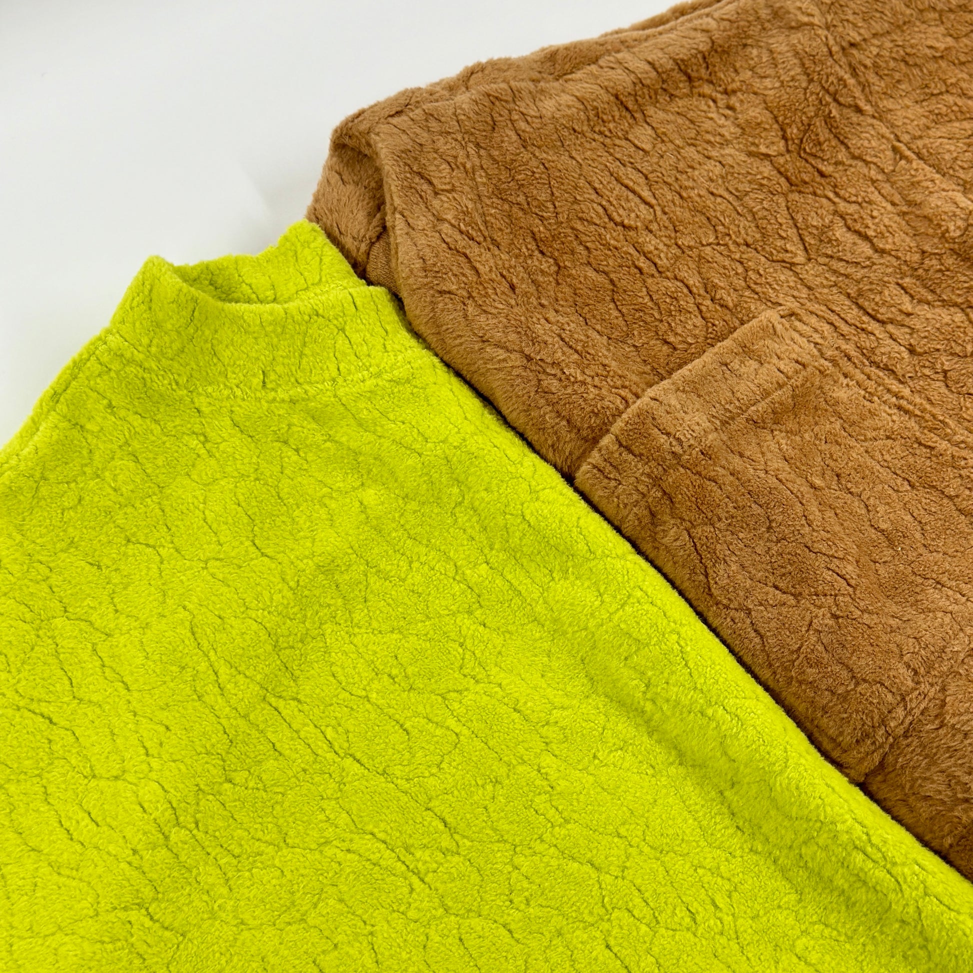 A close up of both colours of the  Studio Koter Riverson Teddy Sweatshirts in vibrant acid green and caramel brown