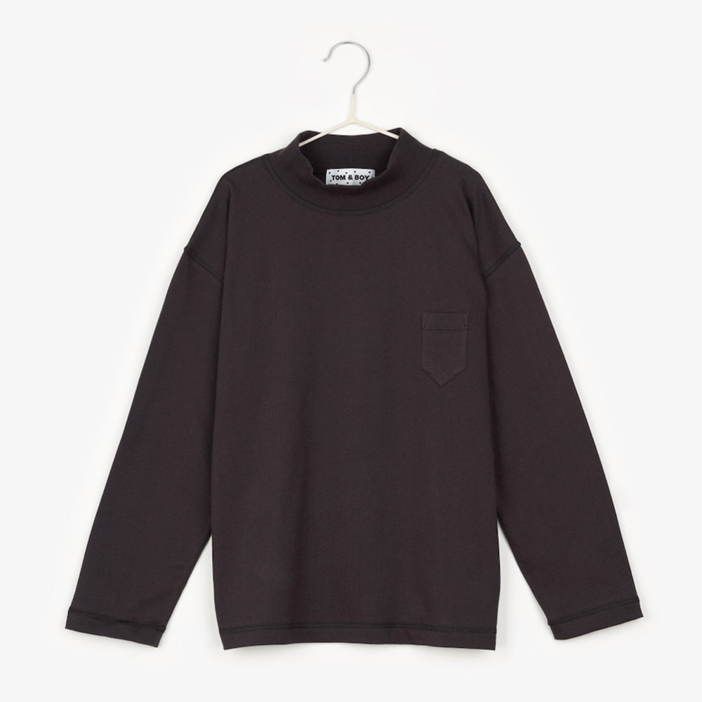 an off black long sleeve t-shirt with a high neck and a small triangular pocket on the right hand side of the shirt, on the chest area 