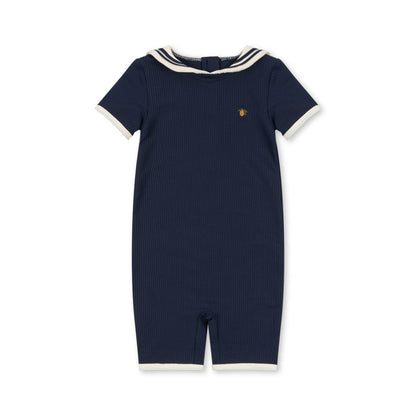 Navy blue retro swimsuit with white trim on a white background
