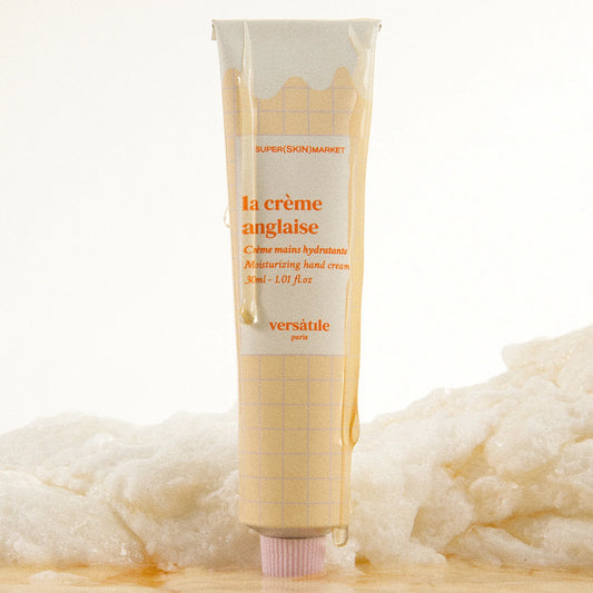 Hand cream tube labeled 'la crème anglaise' with a soft white background