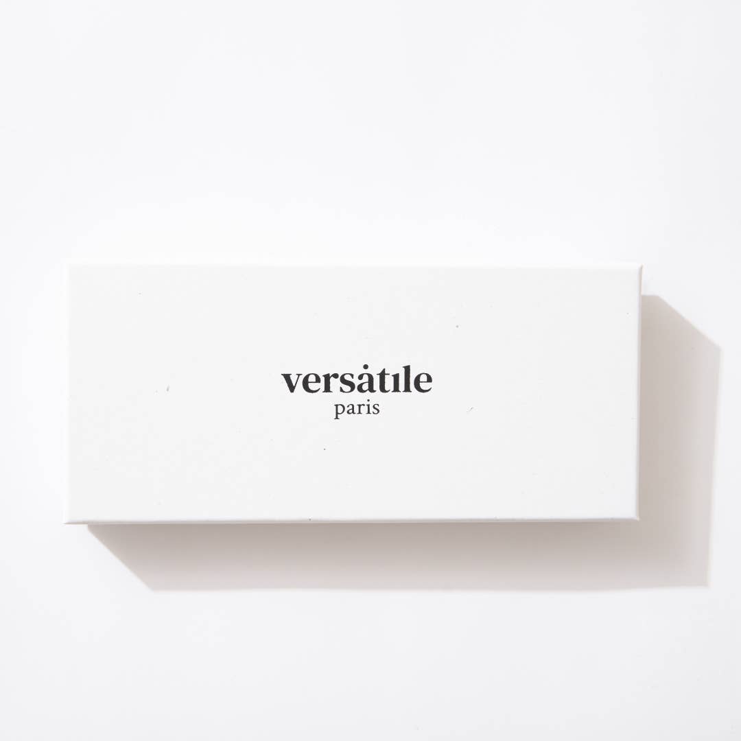 A white rectangular box with the logo Versatile Paris embossed on it