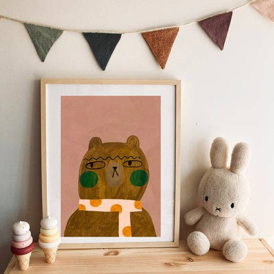 Cool Bear art print featuring a brown bear with green cheeks and an orange spotty scarf on a pink background, perfect for children's decor.