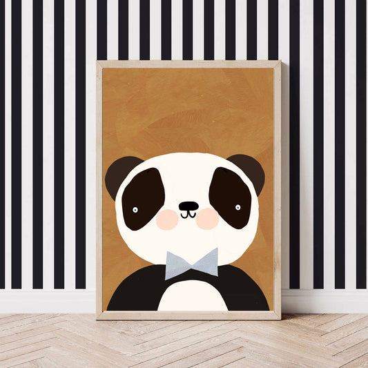 Mr Panda art print featuring a cute panda with pink cheeks, a blue-grey bow tie, and a warm brown background, perfect for children's decor. It sits against a wall with black and white vertical striped wallpaper. 