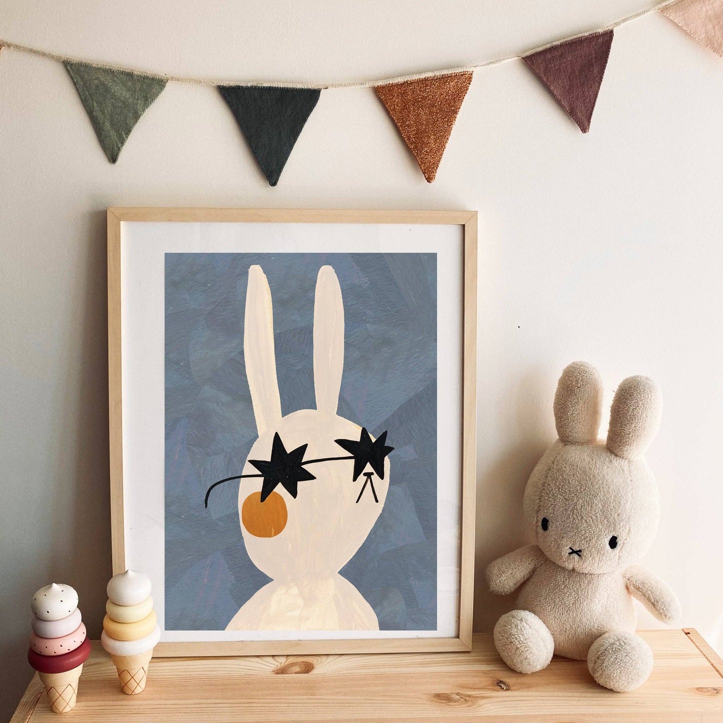 Mr Rabbit art print featuring a stylish white rabbit with rosy cheeks and black star-shaped sunglasses on a blue background, perfect for children's decor.