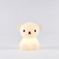 A silicone nightlight designed to look like a teddy bear with a subtle glow coming from its body.