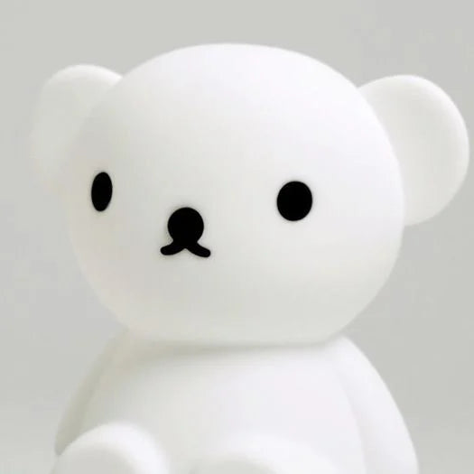 Close up of Boris First Light Lamp, a silicone nightlight designed to look like a teddy bear against a white background.