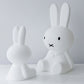 Mr Maria Miffy XL Lamp, 80 cm tall, iconic statement piece with six brightness settings, inspired by Dick Bruna's classic illustrations. Sat next to the smaller Miffy Star Light