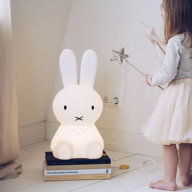 Miffy Star Light (50 cm) by Mr Maria, a charming lamp featuring the iconic character designed by Dick Bruna, perfect for kids' rooms with six brightness levels, including night mode. Sits in a Childs room where we see a young girl wearing a tutu holding a star wand