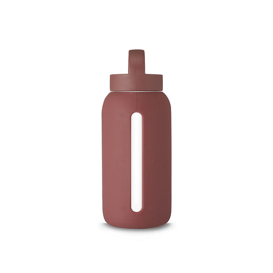 A matte Silicone covered glass bottle, with a window to see the drink on the inside, in a deep plum purple colour with a plastic screw top circular lid with a handle