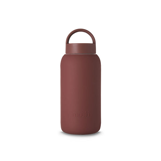 A matte Silicone covered glass bottle, with a window to see the drink on the inside, in a deep Plum Purple colour with a plastic screw top circular lid with a handle