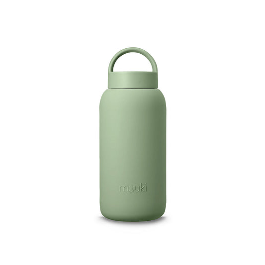 A matte Silicone covered glass bottle, with a window to see the drink on the inside, in a muted sage green colour with a plastic screw top circular lid with a handle