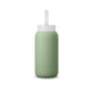 A matte Silicone covered glass bottle, with a window to see the drink on the inside, in a muted sage green colour with a plastic screw top circular lid with a handle