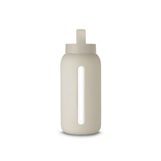 A matte Silicone covered glass bottle, with a window to see the drink on the inside, in a creamy white colour with a plastic screw top circular lid with a handle