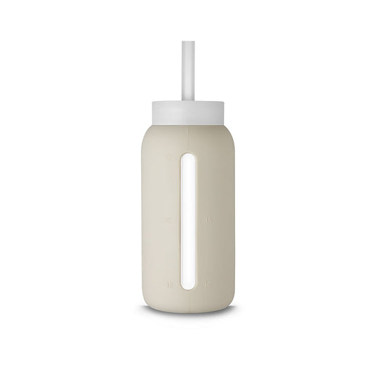 A matte Silicone covered glass bottle, with a window to see the drink on the inside, in a creamy white colour with a plastic screw top circular lid with a handle