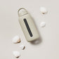 A matte Silicone covered glass bottle, with a window to see the drink on the inside, in a creamy white colour with a plastic screw top circular lid with a handle