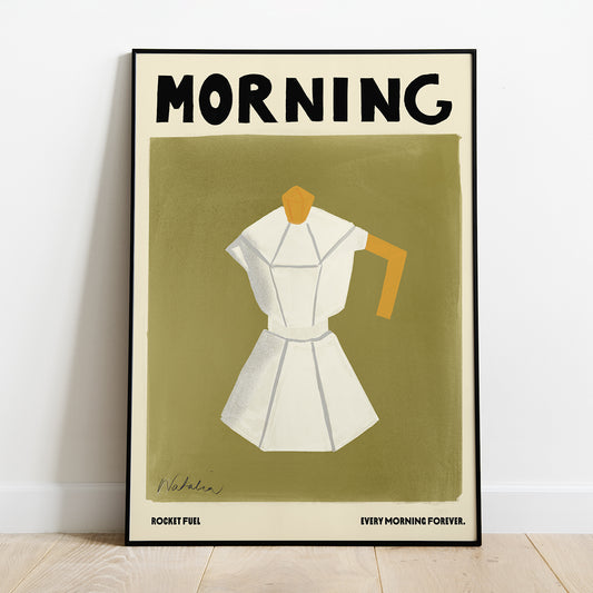 A Natalia Bagniewska Morning Print. The background is bright olive green. The jug is white with grey edges. The lid and holder of the jug is ochre yellow in colour. Beneath the olive green background, in black, on the left hand side it says Rocket Full and on the right hand side it says Every Morning Forever. The print is framed and kept against a white wall on a wooden floor. 