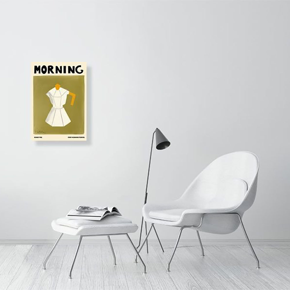 A Natalia Bagniewska Morning Print in a drawing room setting. In the print, the background is bright olive green. The jug is white with grey edges. The lid and holder of the jug is ochre yellow in colour. The print is framed and hung on a white wall. The chair, stool, floor are all white. 