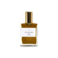 A glass bottle with a gold lid. The label is white with black text. The perfume is a dark gold colour.