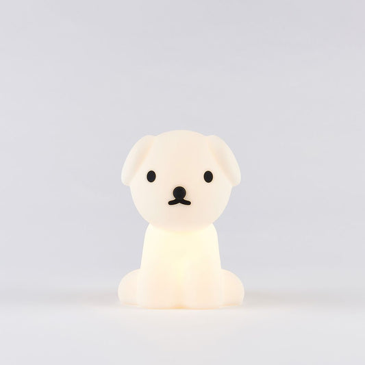 A small, white silicone lamp in the shape of a dog, designed to provide a soft glow.