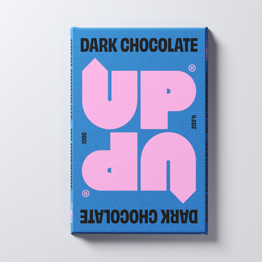 A blue and pink chocolate bar packaging with the text 'DARK CHOCOLATE' and the brand name 'UP-UP CHOCOLATE' in large pink letters on a blue background.