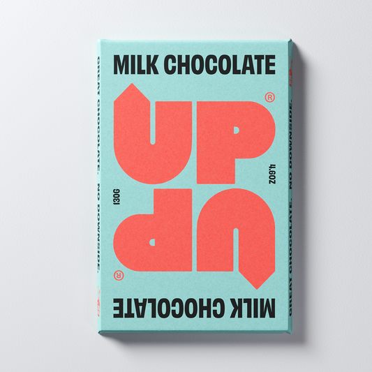 A bar of UP-UP Chocolate milk chocolate, with red and black text on a teal background.
